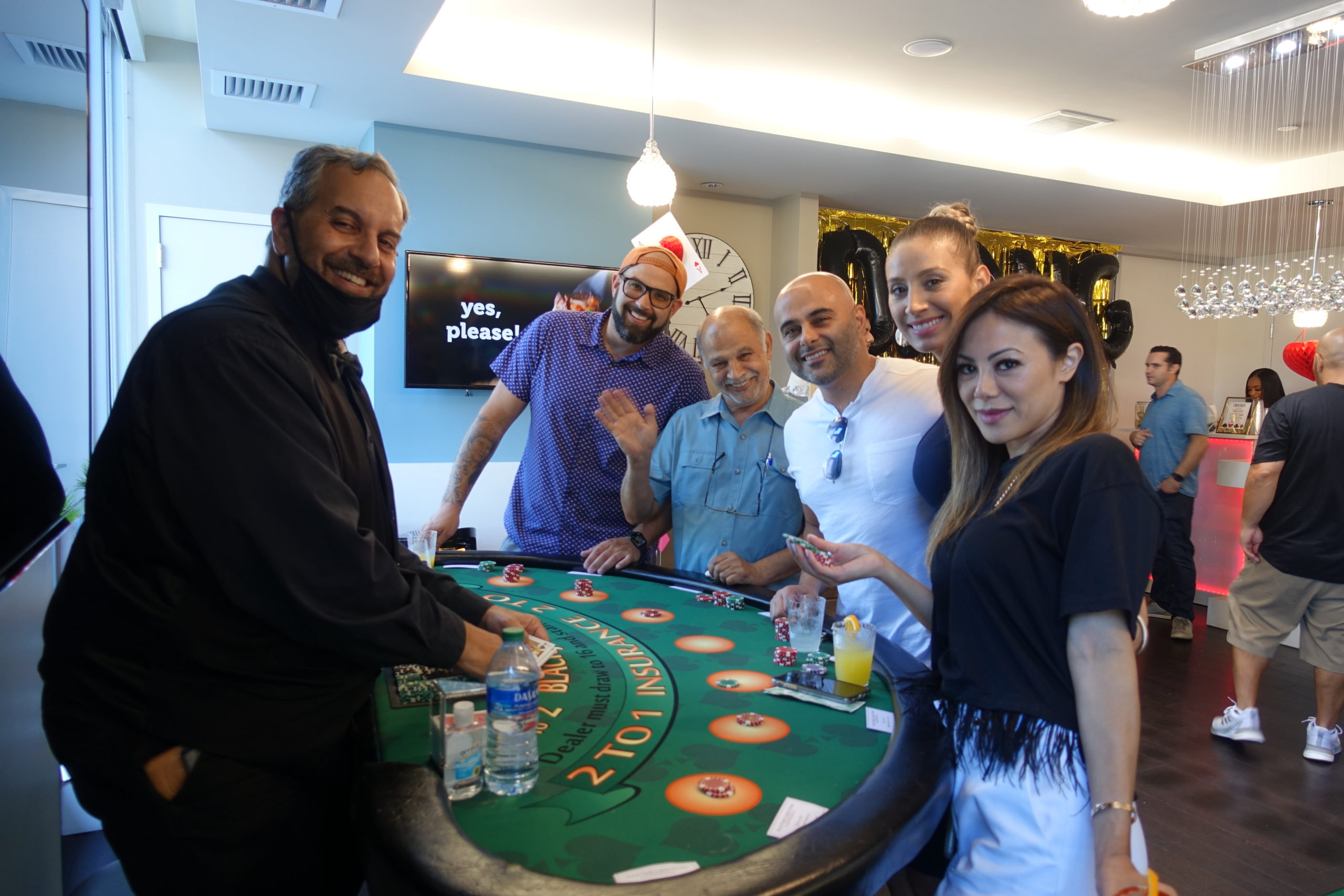 A full blackjack table at a casino-themed event
